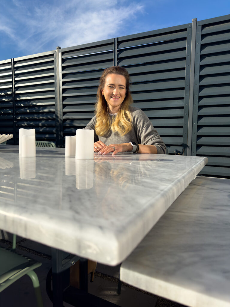 Woman sitting at marble table outdoors